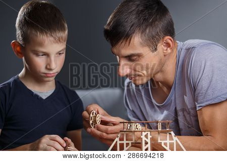 Young Boy Assembling Constructor With His Father