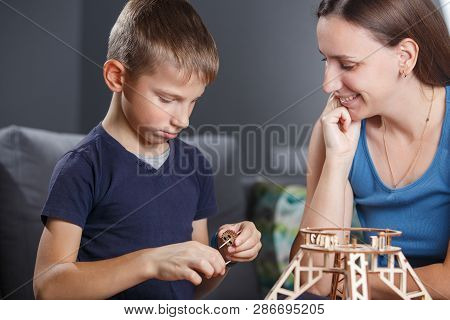 Young Boy Assembling Constructor With His Mother.