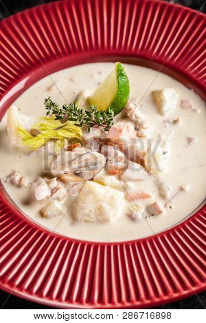 The Concept Of American Cuisine. Clam Chowder Potato Soup With Sea Food, Mussels, Salmon. Fish Broth
