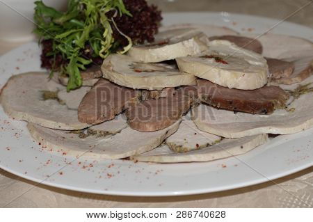 Thin Large Slices Of Meat, Ham Or Brisket, Decorated With Lettuce Leaves. Meat Sliced, Laid Out Of S