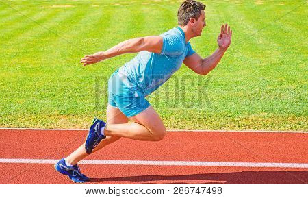 Runner Captured In Motion Just After Start Of Race. Runner Sprint Race At Stadium. Boost Speed Conce