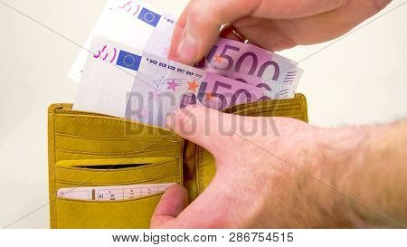 Man Couting Off The 2000 Euro Bills On The Wallet. On The Wallet Are 4 500 Euro Bills Then Thrown On