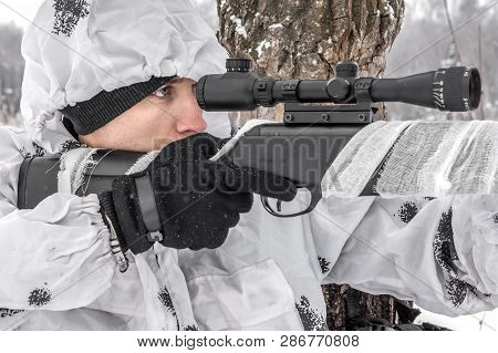 Closeup Portrait Man Soldier In The Winter On A Hunt With A Sniper Rifle In White Winter Camouflage