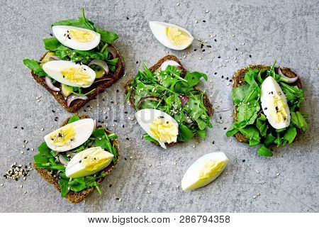 Healthy Fitness Toasts With Arugula And Egg. Useful Snack Lunch. Useful Vegetarian Toast. Open Sandw