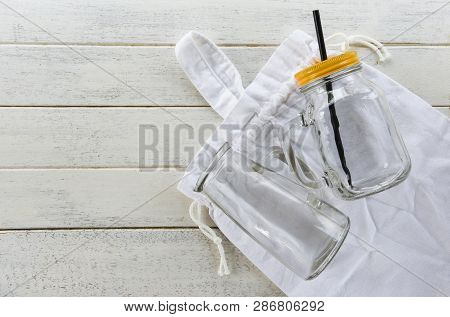 Zero Waste Use Less Plastic Concept / Glass Gar Eco Cotton Bags Free Plastic Shopping On White Woode