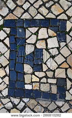 Portuguese Sidewalk Of Calcada In The Form Of The Letter E. Lisbon, Portugal