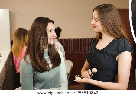 Make Up Artist Doing Professional Make Up Of Young Woman. Beauty Shcool