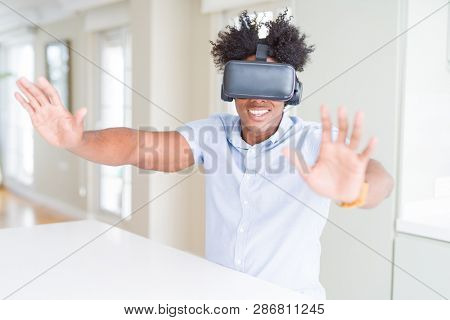 African amaerican man having fun playing with virtual reality glasses