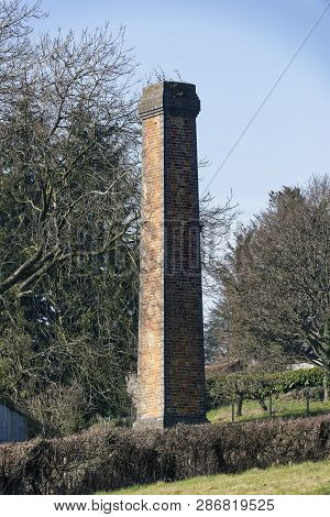 Old Industrial Chimney Stack In Field 
Ganders Green, Below May Hill, Gloucestershire, Uk