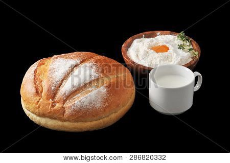 Round Loaf Of Bread, Milk In A Cup And The Flour