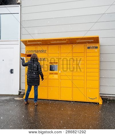 Strasbourg, France - Feb 8, 2018: Young Woman Amazon Locker The Self-service Parcel Delivery Service