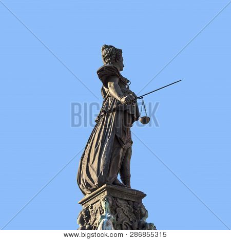 Lady Justice Standing At The Fountain Under Blue Sky In Frankfurt As A Symbol Of Justice