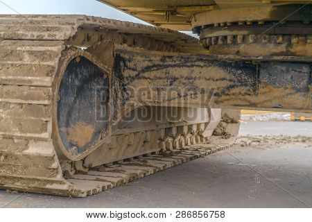 Excavator With Caked Mud On The Grouser Pad
