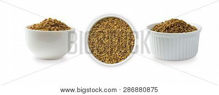 Fenugreek Seeds In A Wooden Bowl Isolated On White. Fenugreek Seeds Isolated On White Background. Fe