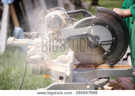 Master Carpenter At Work In The Workshop Outdoors. Carpenter Han