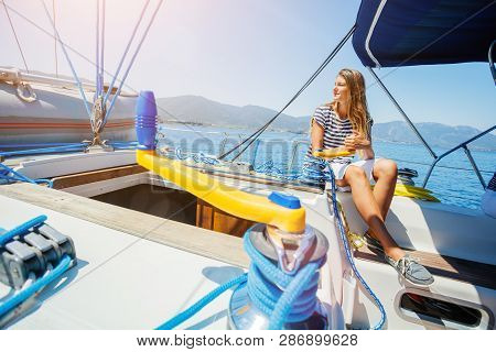 Girl On Board Of Sailing Yacht On Summer Cruise. Travel Adventure, Yachting With Child On Family Vac