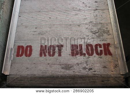Do Not Block Sign Painted On Melal Background