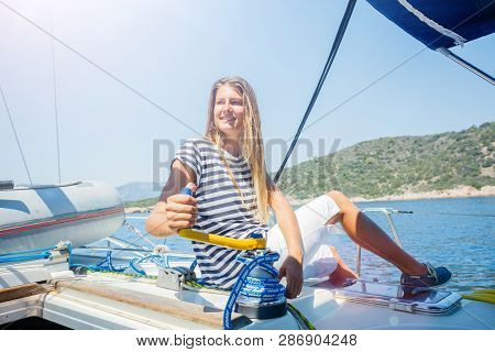 Girl On Board Of Sailing Yacht On Summer Cruise. Travel Adventure, Yachting With Child On Family Vac