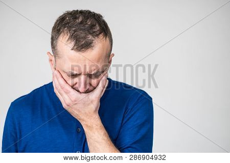 Depressed, Sad, Worried Adult Man Covering His Mouth Feeling Guilt And Shame.