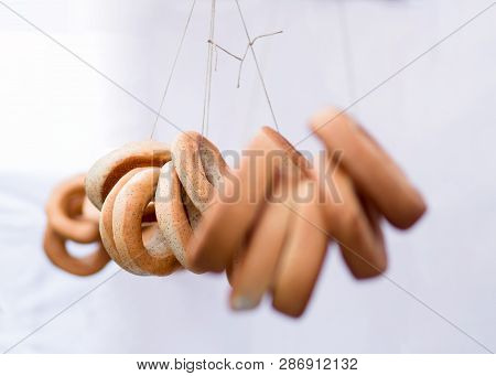 Ring-shaped Rolls In A Fare For Sale On White Background, Bagels, Bread Ring