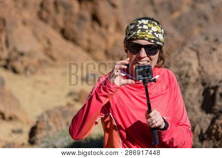 Adventure Female Vloger Using Action Camera Outdoor.