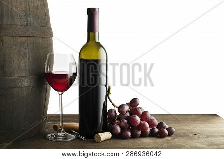 Glass And Bottle Of Red Wine With Wooden And Barrel Background Isolated On White