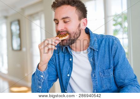 Handsome man eating amazing pizza and enjoying at home