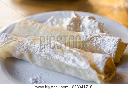 A White Plate With Food And A A White Cup Are On The Wooden Table. Ready To Eat Concept. Tasty Food 
