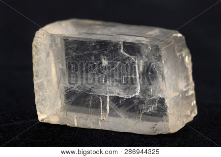 Raw Iceland Spar From Krasnoyarsk Region, Russia On Black Cement Background.