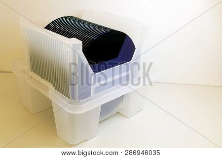 Silicon Wafers In White Plastic Holder Box On A Table- A Wafer Is A Thin Slice Of Semiconductor Mate