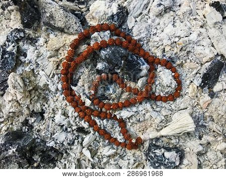 Rosary Prayer Beads On The Ash Cinder Background. Rudraksha. Mala. Mantra. 108 Beads.