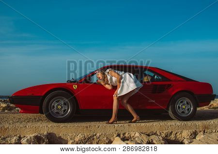 Young Girl Do Makeup In The Rear View Mirror Of Ferrari