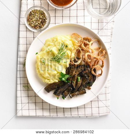 Fried Beef Liver With Mashed Potatoes And Fried Onion Rings On White Plate. Pieces Liver (offal) Fro