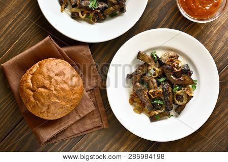 Cooked Beef Liver With Onion On Plate Over Wooden Background. Pieces Fried Liver (offal) From Beef. 