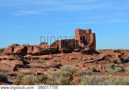 Scenic View Of Pueblo Red Rock Village Against A Blue Sky.