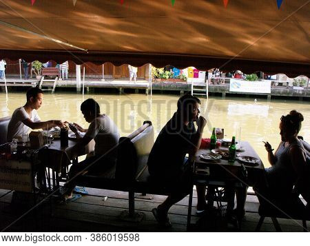 Amphawa, Thailand, January 23, 2016: People Enjoying Food On The Edge Of The Canal At Amphawa Floati