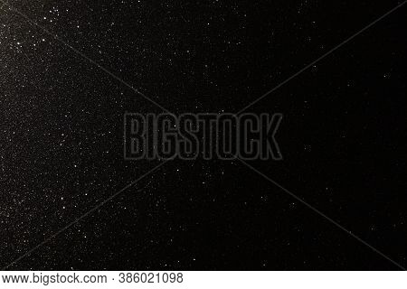 Black Texture With Micro-relief And Glitter Similar To The Night Sky With Stars
