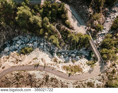 Road And Bridge Over Mountain Stream In Corsica