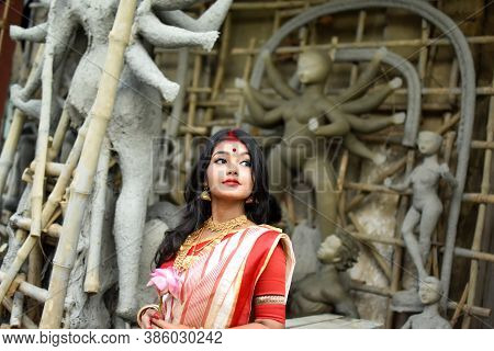 Portrait Of Beautiful Indian Bengali Female Woman In Red And White Traditional Ethnic Saree And Jewe