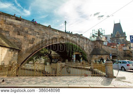 Arch Of The Old Charles Bridge In Prague Above The Devil River Channel Chertovka. Prague / Czech Rep