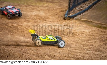 Yellow Electric Rc Buggy Racing On An Offroad Outdoor Track