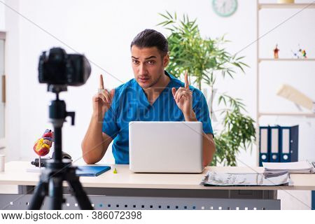 Young male doctor recording video for his blog