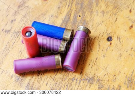 Hunting Cartridges For A Smoothbore Rifle On An Old Wooden Lacquered Table Surface. Selective Focus.