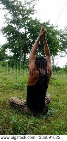 District Katni, India - August 05, 2019: An Indian Village Man Doing Yogasana On Shorts At Green Hor