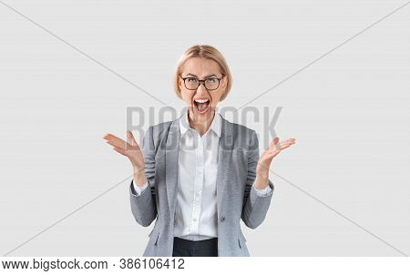 Attractive Female Entrepreneur In Formal Wear Screaming In Anger On Light Background. Company Employ