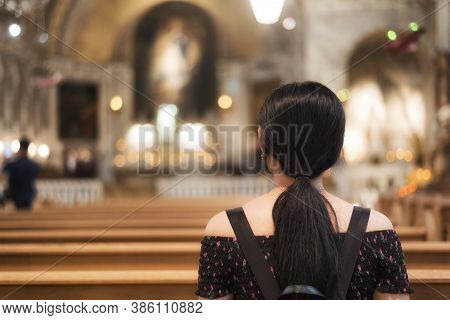 A Chinese Woman Sitting In A Pew Within The Historial Chapelle Notre Dame De Bon Secours In Old Mont