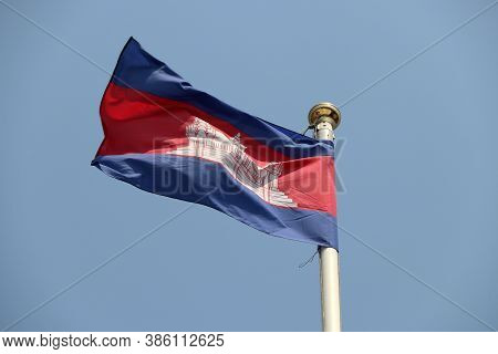 National Flag Of Cambodia On Bright Blue Sky Background. Blown Away By Wind. Cambodia Is One Of The 