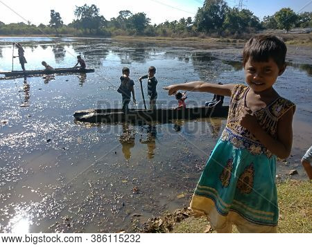 City Katni, India - December 03, 2019: An Indian Village Poor Girl Pointing Finger On Water Lake At 