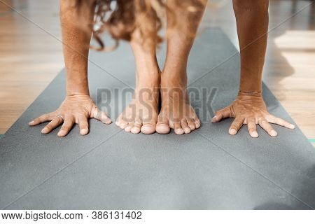 Standing Forward Bend Pose In Yoga Iyengar, Uttanasana Fold Pose Close Up Front View