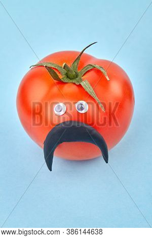 Funny Manlike Tomato With Moustache. Red Male Tomatoe Isolated On Blue Background.